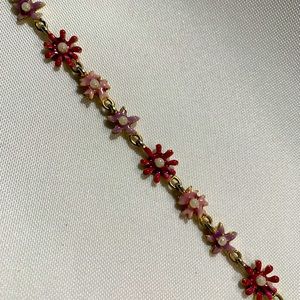 Gold chain bracelet, with pink/purple flowers
